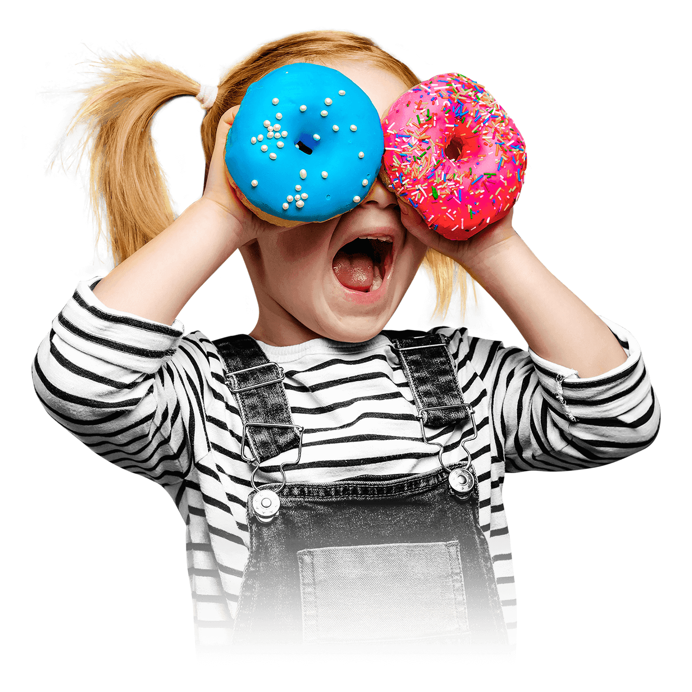 A child with open mouth looking through donuts in her hands.