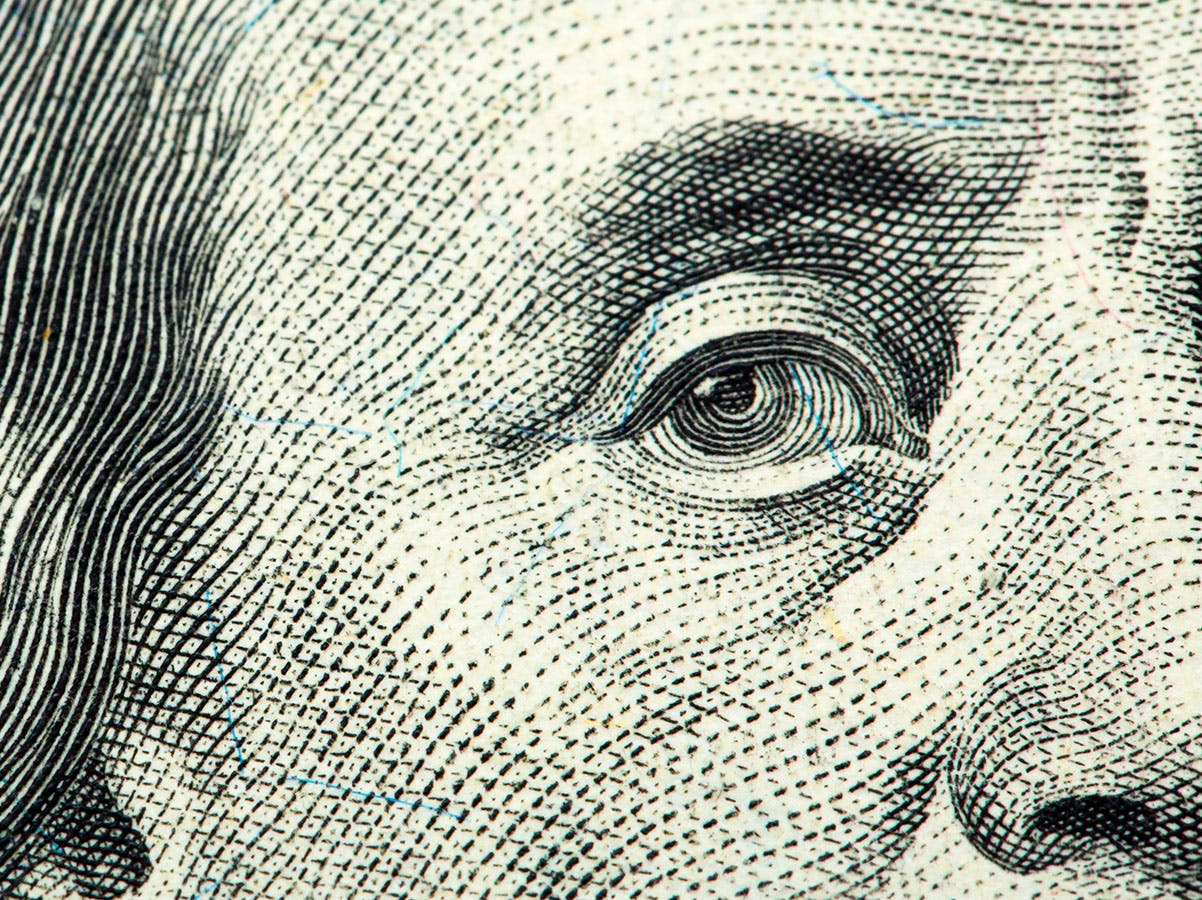 Close-up of a hundred-dollar bill focusing on the face.
