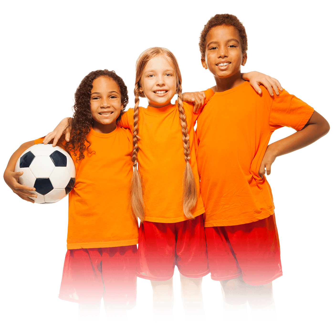 Three children in orange jerseys and red shorts posing together with a soccer ball.