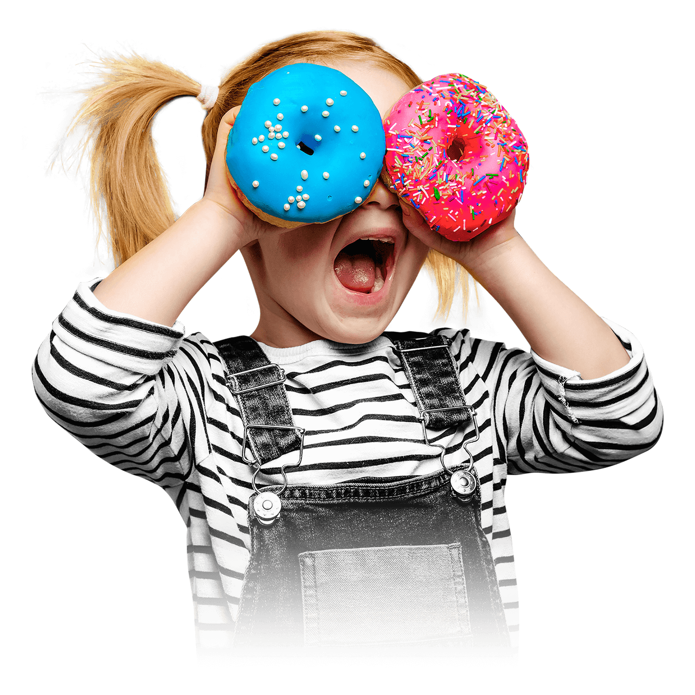 A child with open mouth looking through donuts in her hands.
