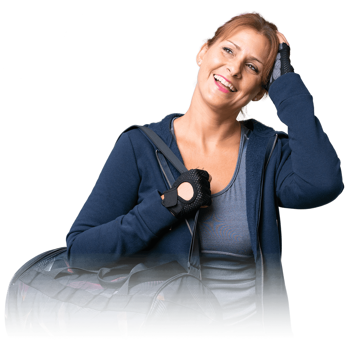 A woman in a sweatshirt and gloves, with a backpack on her shoulder, smiling in gym attire.