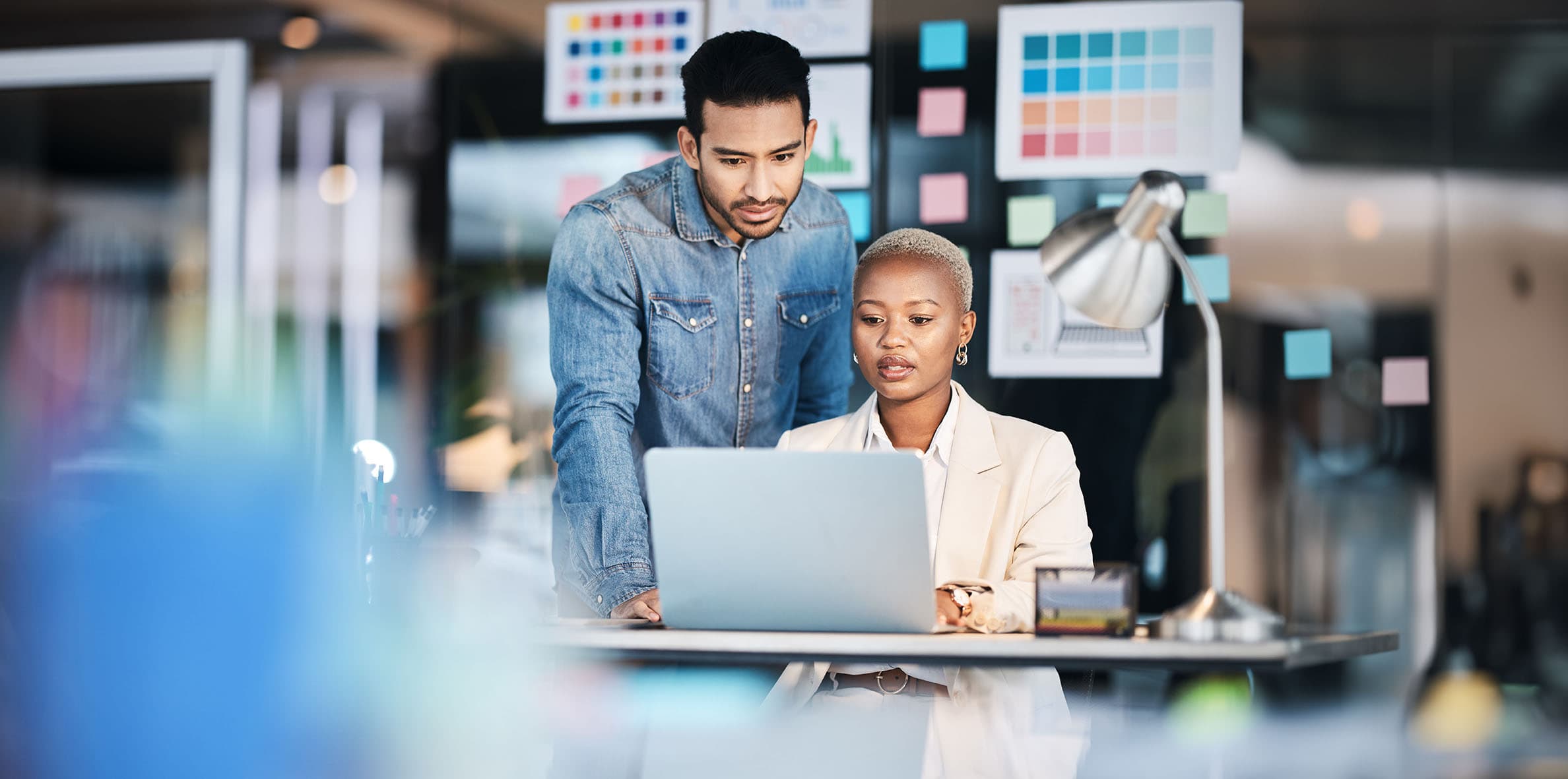A man and a woman collaborating to showcase the creation of a nonprofit website as part of Daxko's website services.