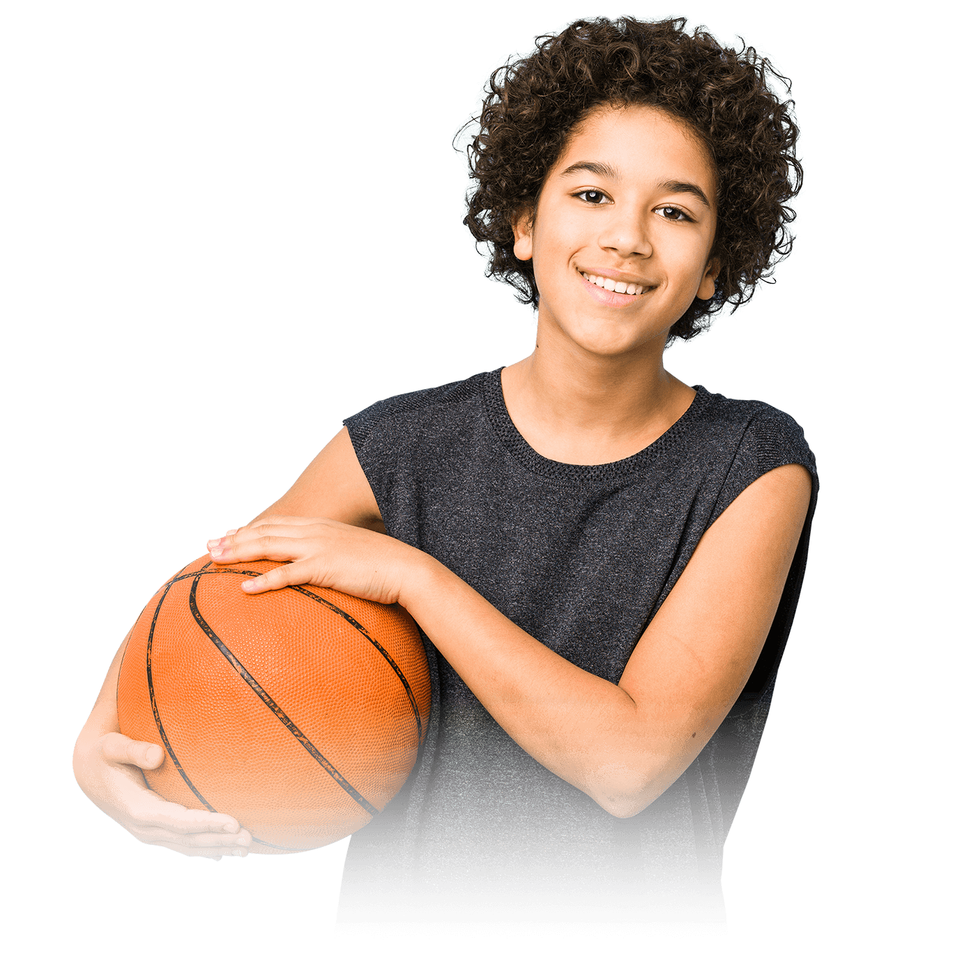 A young boy in a gray t-shirt holding a basketball.