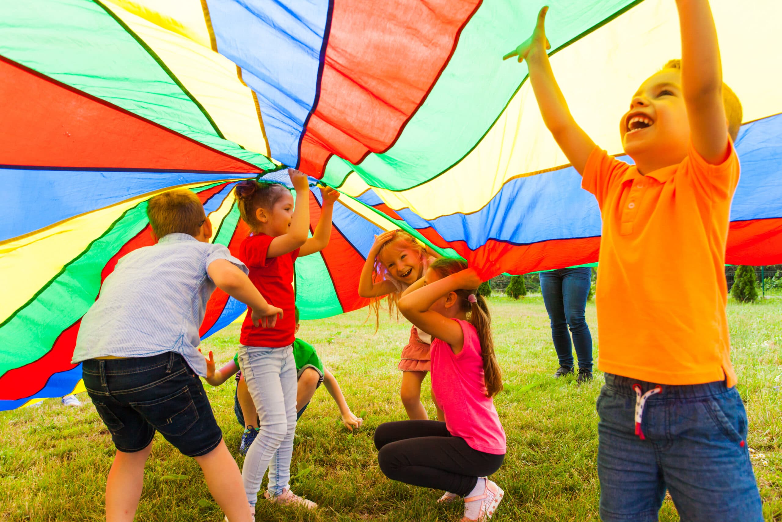 Kids playing under a large colorful cloth